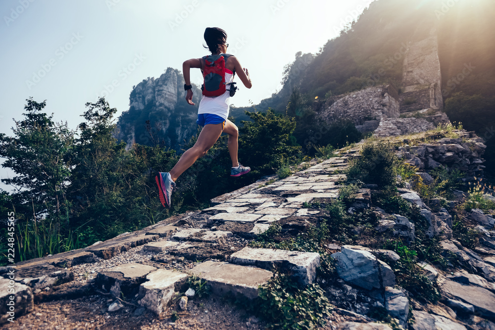 Sporty fitness woman runner running on mountain top - obrazy, fototapety, plakaty 