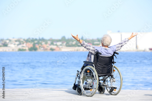 Wallpaper Mural Happy senior woman in wheelchair near river Torontodigital.ca