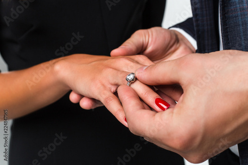 The perfect moment. Close-up of loving men putting ring to his girlfriend 