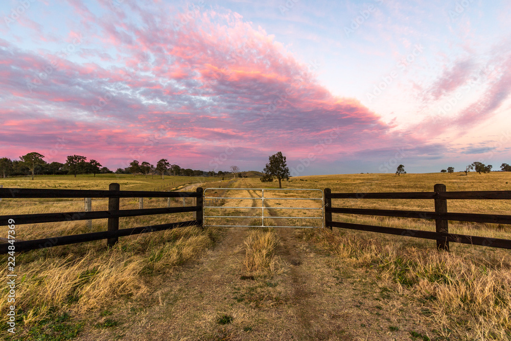 Country timber farm gate with colourful sky