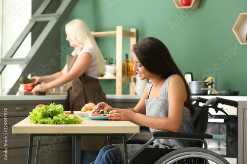 Young woman in wheelchair e...