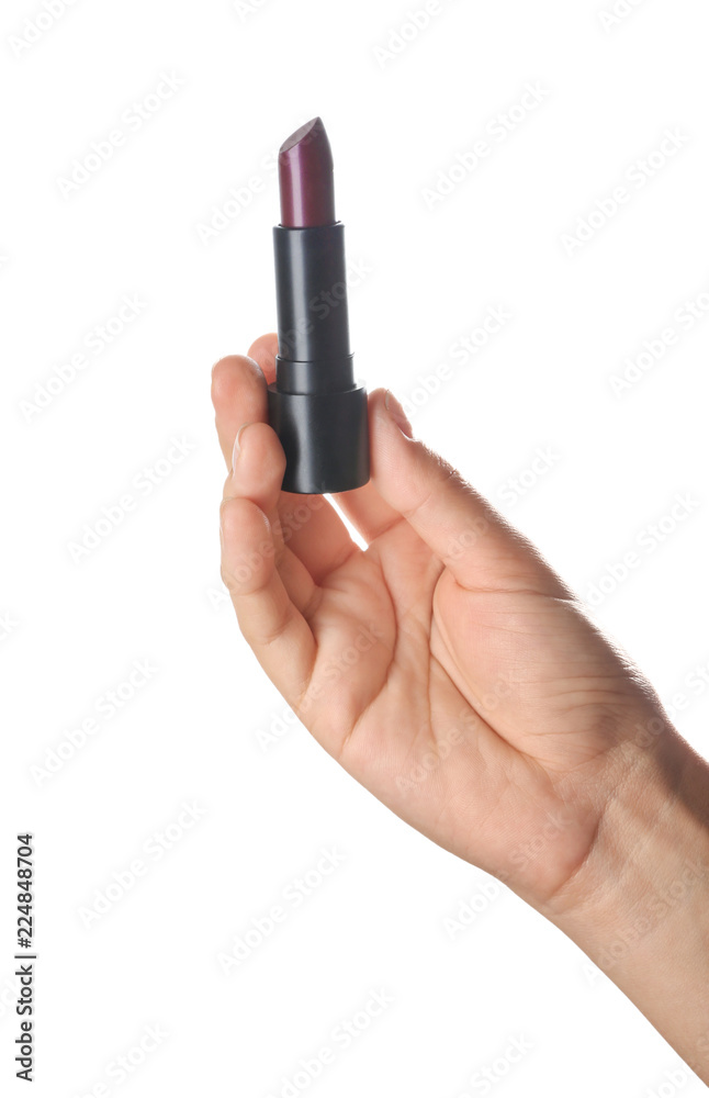 Woman holding dark color lipstick on white background Woman holding dark color lipstick on white background