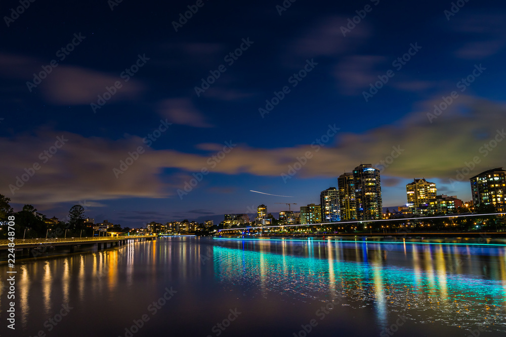 City dividing river at night