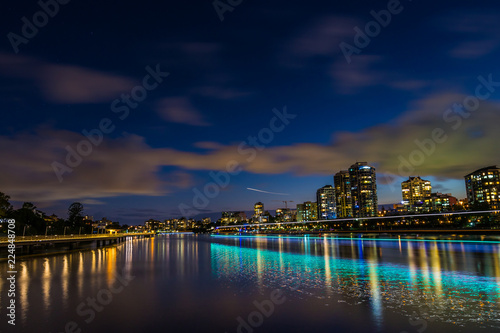 City dividing river at night © Gabriel
