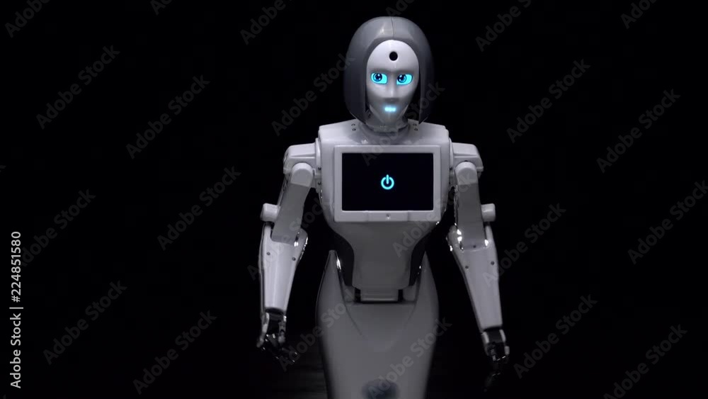 Robot dances in a dark room. Black background Robot dances in a dark room. Black background
