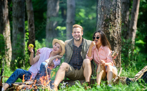 Halt for snack during hiking. Company hikers relaxing at picnic forest background. Camping and hiking. Relax and fun in nature. Company friends relaxing and having snack picnic nature background