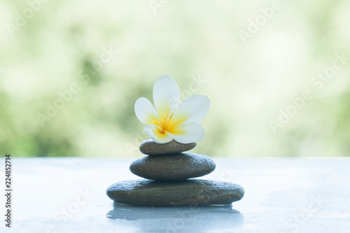 spa set with flower and stones on white marble background.