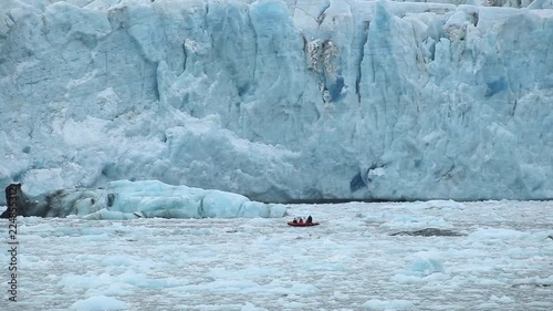 Scientists near the wall of the glacier.