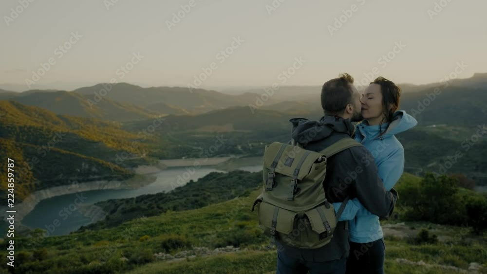 Couple standing on top of mountain Couple standing on top of mountain