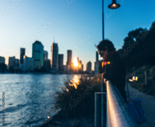 Woman near fence of city promenade