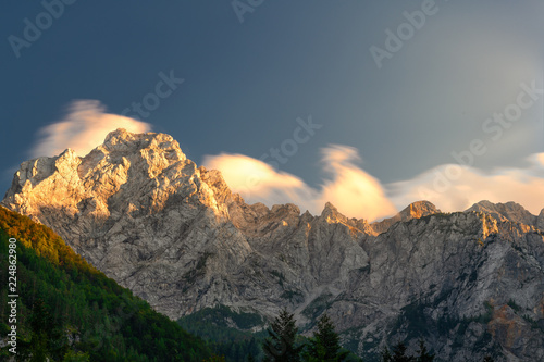 Cloudscape in sunset above mountain ridge photo