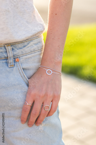 Female hand with silver jewelery, rings and bracelets minimalistic style
