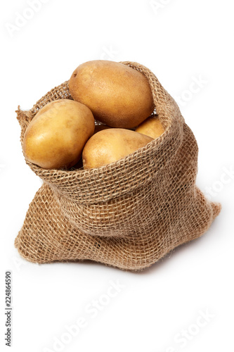 Burlap sack of fresh raw potatoes isolated on white background