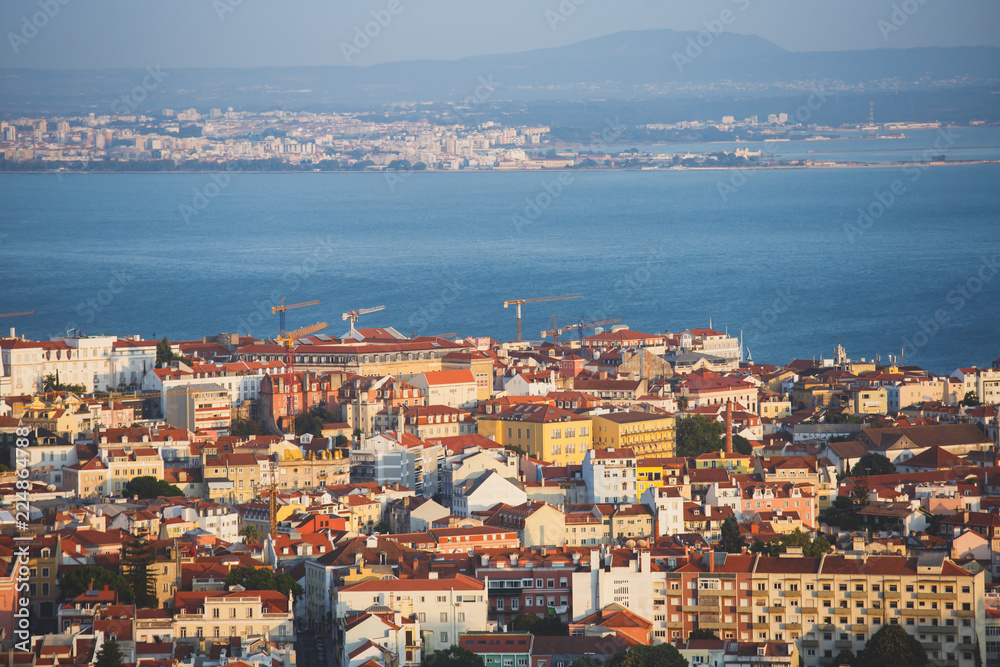 Beautiful super wide-angle aerial view of Lisbon, Portugal with harbor, skyline, scenery beyond the city and 25 de Abril Bridge, over the Tagus river, shot from belvedere observation deck