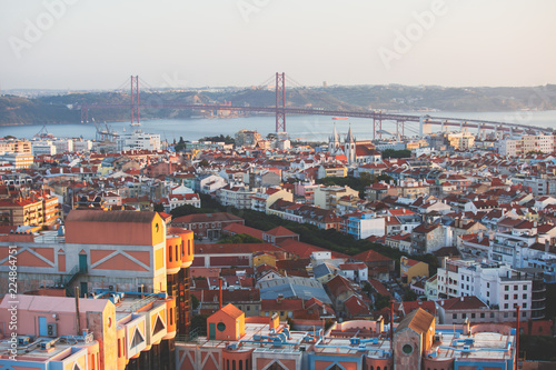 Beautiful super wide-angle aerial view of Lisbon, Portugal with harbor, skyline, scenery beyond the city and 25 de Abril Bridge, over the Tagus river, shot from belvedere observation deck