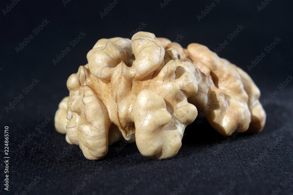 Purified walnut on dark fabric background Selective focus Purified walnut on dark fabric background Selective focus