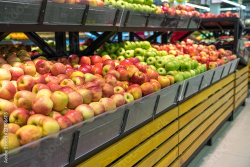 Fresh healthy fruits on shelves in supermarket