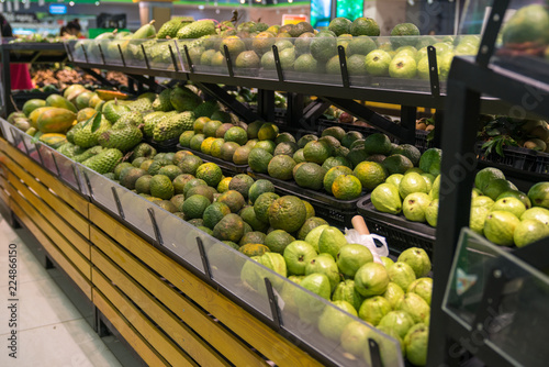 Fresh healthy fruits on shelves in supermarket