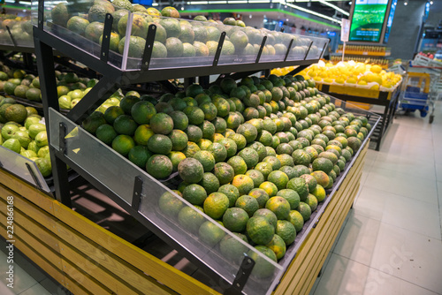 Fresh healthy fruits on shelves in supermarket
