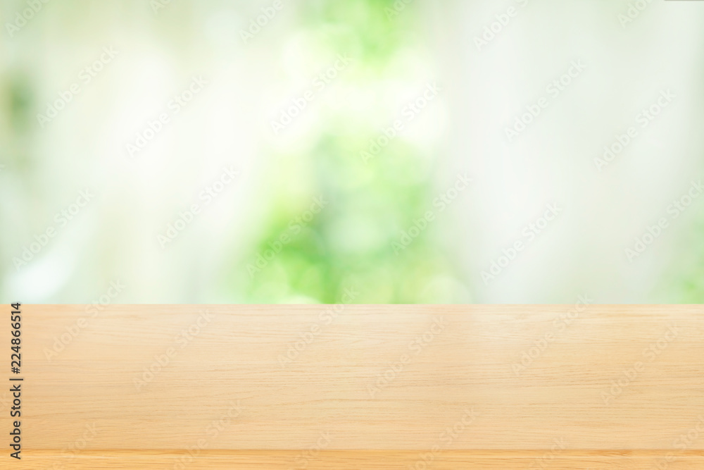 Empty of wooden table top on blur of abstract green from garden with sunlight and curtain window background , product display, for display or montage of product Empty of wooden table top on blur of abstract green from garden with sunlight and curtain window background , product display, for display or montage of product