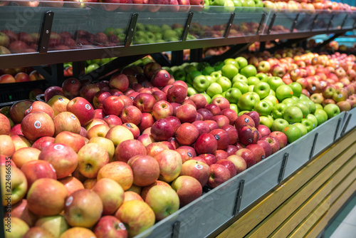Fresh healthy fruits on shelves in supermarket