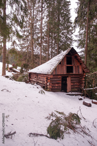 A hut in the winter forest. The hunter's house. © vzwer