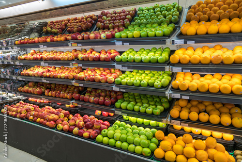 Fresh healthy fruits on shelves in supermarket