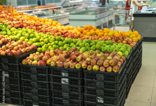Fresh healthy fruits on shelves in supermarket