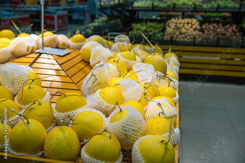 Fresh healthy fruits on shelves in supermarket