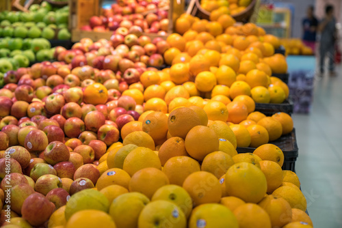 Fresh healthy fruits on shelves in supermarket