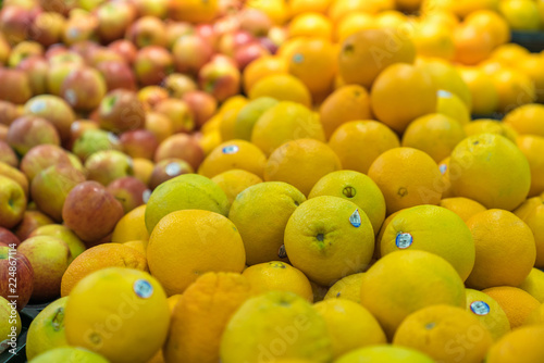 Fresh healthy fruits on shelves in supermarket