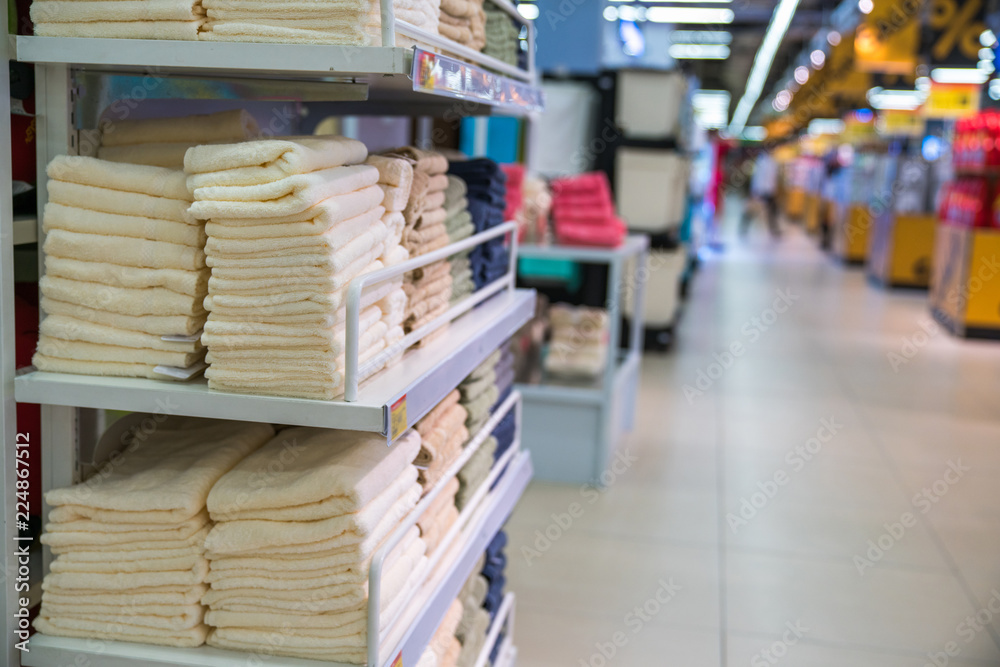 Stacks of colored towels on the shelves in supermarket Stacks of colored towels on the shelves in supermarket