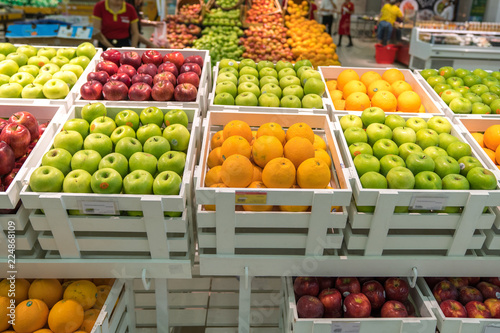 Fresh healthy fruits on shelves in supermarket