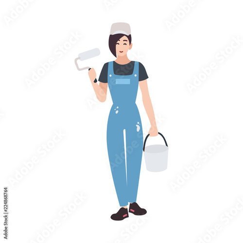 Joyful house painter or decorator wearing dungarees and holding paint roll and bucket