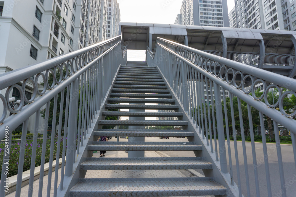Fototapeta premium Steel stair step to walk up or walk down to the outdoor public bridge