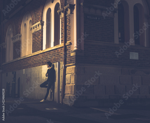 Human standing near corner of building on street