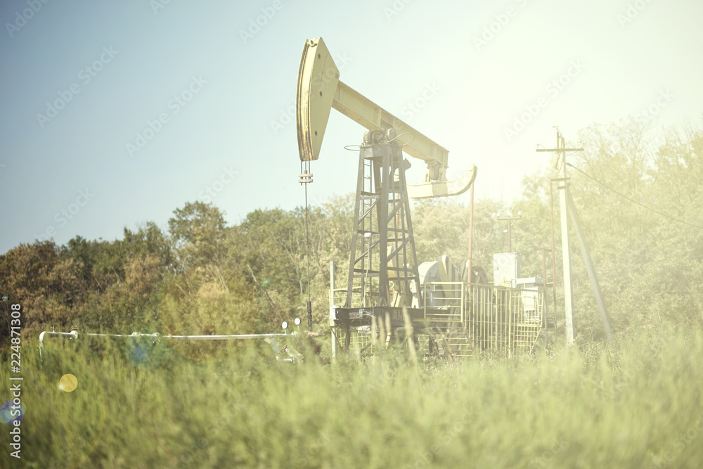 Oil pumps are working in the blue sky background Oil pumps are working in the blue sky background