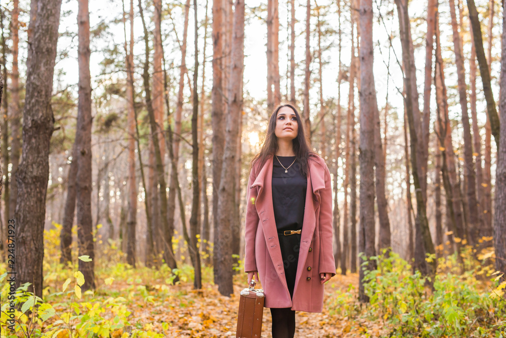 Fall, season and people concept - young woman walking in park at autumn Fall, season and people concept - young woman walking in park at autumn