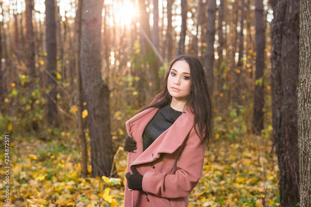 Nature, season and people concept - young woman smiling in autumn park Nature, season and people concept - young woman smiling in autumn park