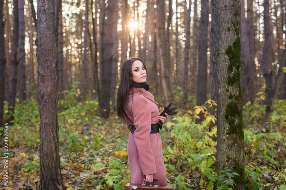 Season, fall and people concept - Portrait of a beautiful brunette woman in autumn nature Season, fall and people concept - Portrait of a beautiful brunette woman in autumn nature