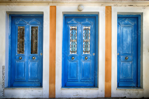 Three old blue doors, Simi Greece photo