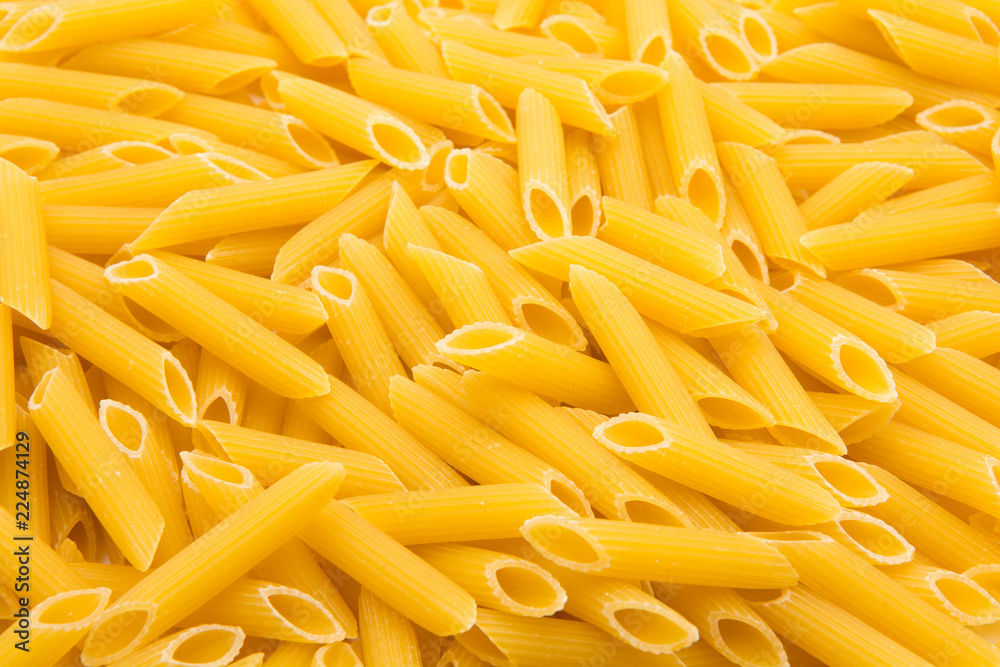 Close up pattern made of raw penne rigate pasta Close up pattern made of raw penne rigate pasta