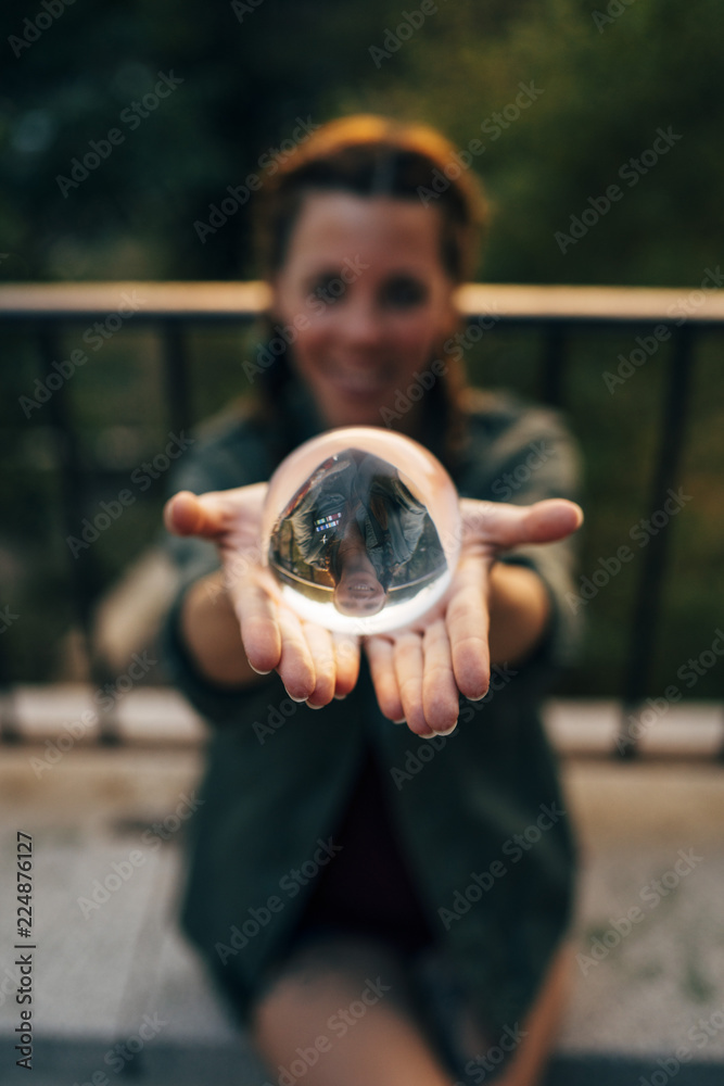 Redhead girl catching a crystal ball. Smile through the ball. Redhead girl catching a crystal ball. Smile through the ball.