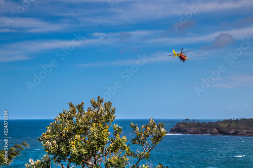 Helicopter flying above blue sea