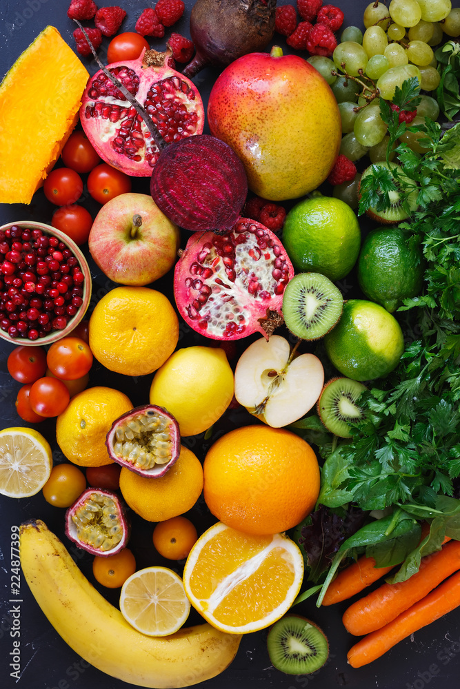 Assortment of different fruits and vegetables in rainbow colors on dark rustic surface, Healthy eating background Assortment of different fruits and vegetables in rainbow colors on dark rustic surface, Healthy eating background