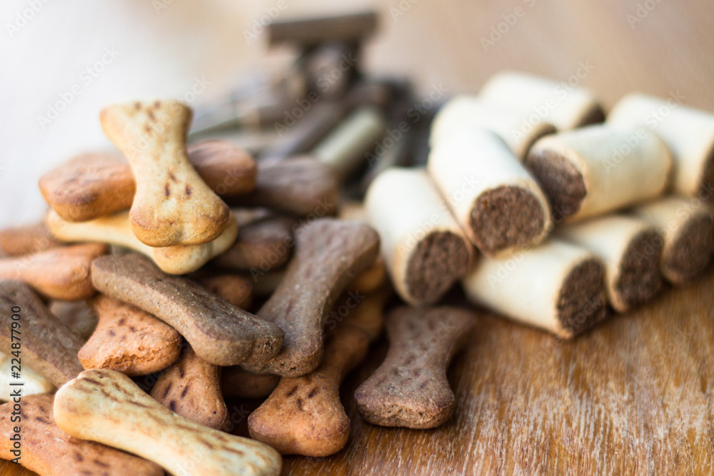 Dog tasty colored biscuits on wooden background, snacks for dogs Dog tasty colored biscuits on wooden background, snacks for dogs