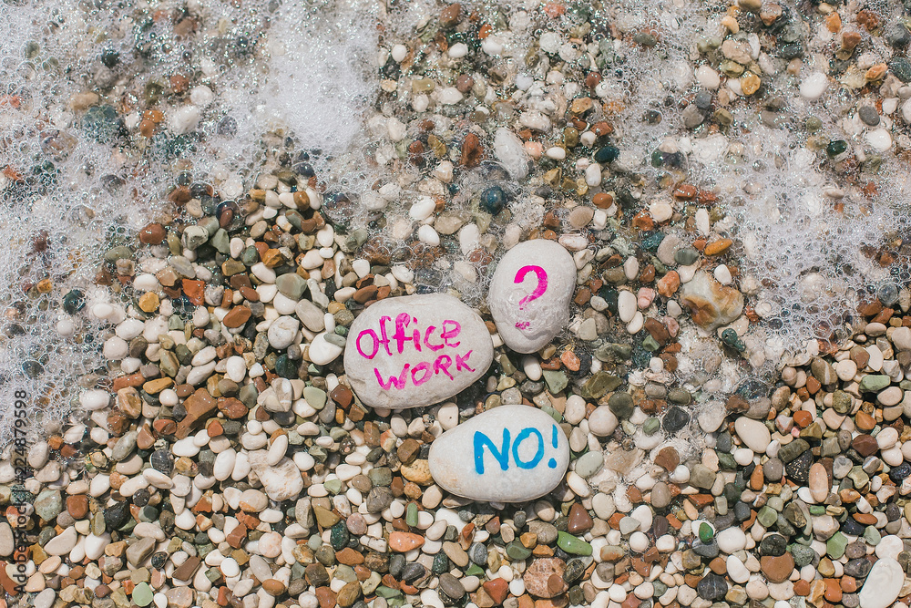 Pebbles with signs on a beach. Freelance. Travels. Love of travel. Office work is boring. Pebbles with signs on a beach. Freelance. Travels. Love of travel. Office work is boring.