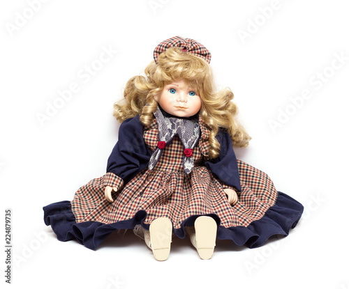 Old porcelain doll on White Background. Concept of time.