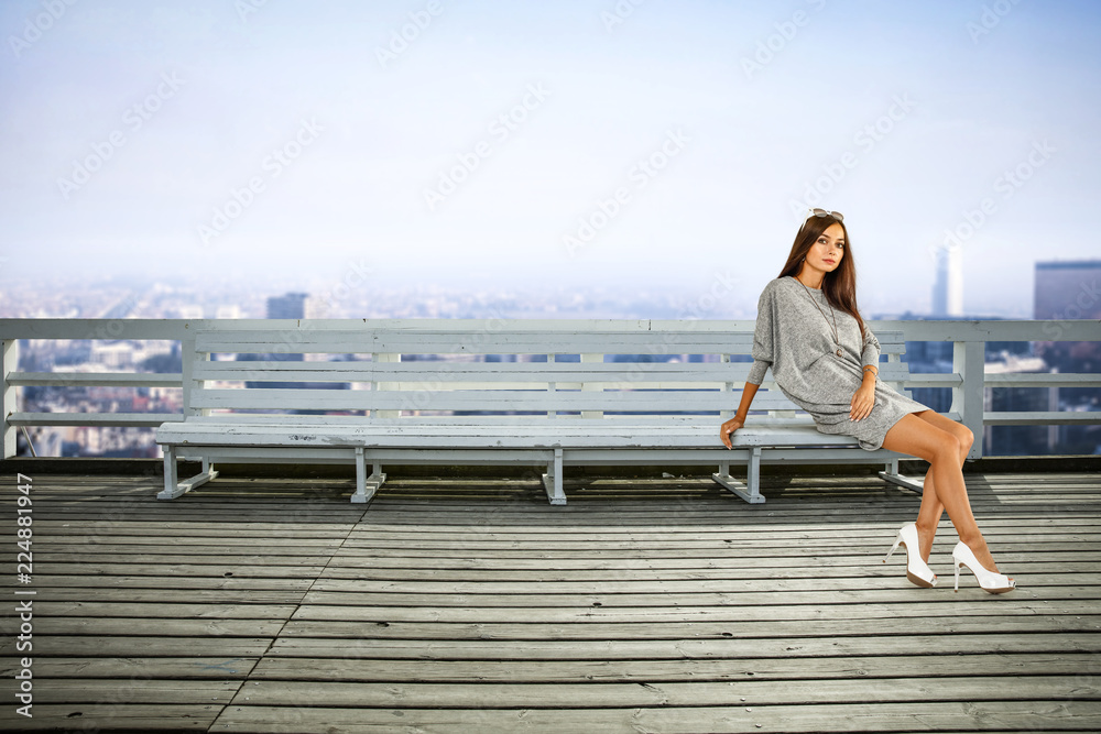 Slim young woman in city and free space for your decoration. 