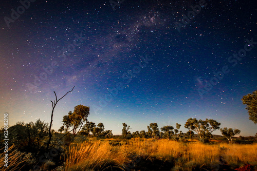 Starry night sky over outback landscape photo